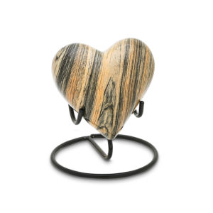 Wooden heart sculpture on stand.