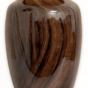 Wooden urn with textured pattern on white background.