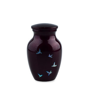 Black vase with blue bird designs on white background.