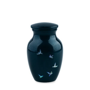 Blue ceramic vase with bird design, isolated background.