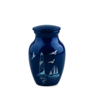 Blue vase with lighthouse and sailboat design.