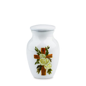 Ceramic urn with floral cross design on white background.